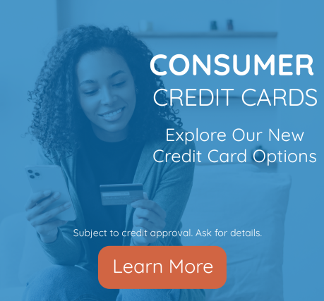 Woman holding phone and credit card exploring credit card options with learn more button