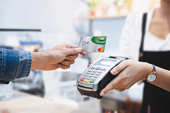 Person using BOGB Consumer Credit Card at Merchant Terminal